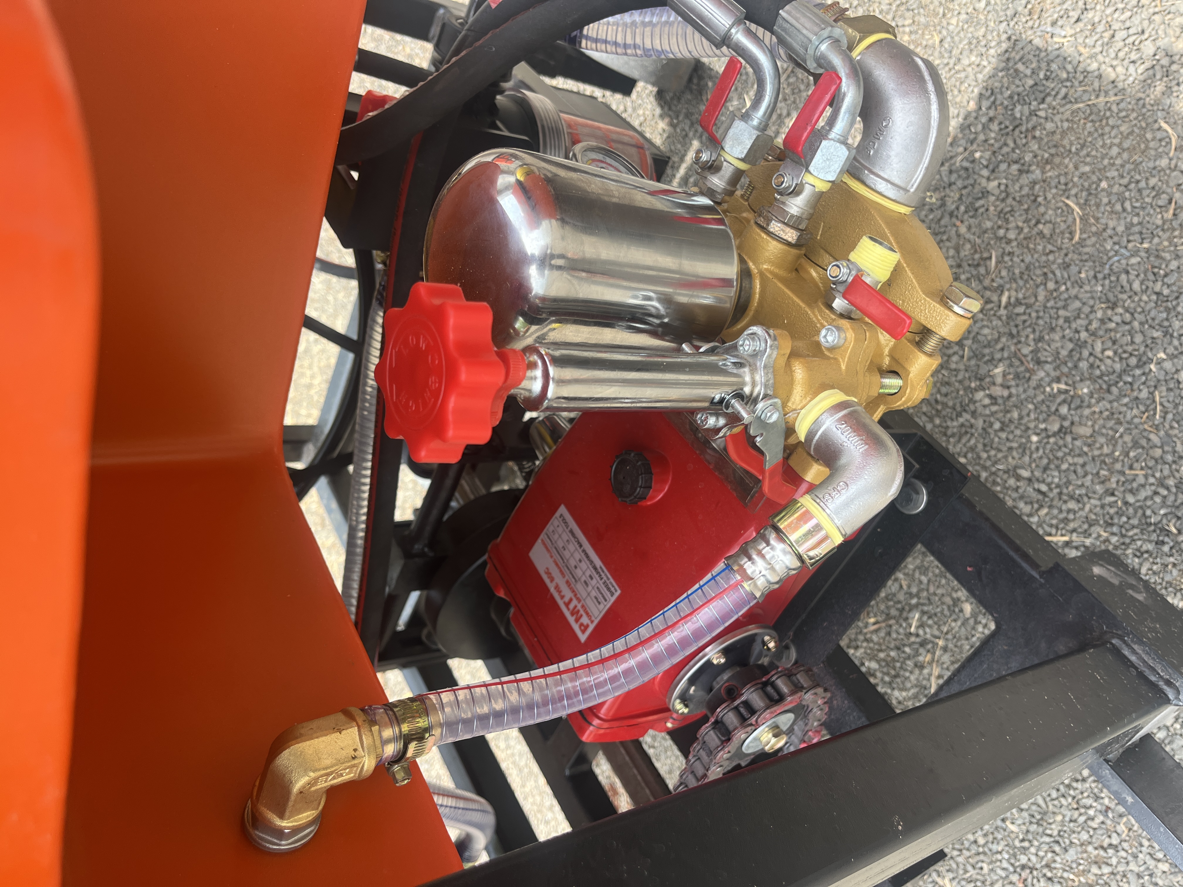 Brass pump, pressure chamber, and red control on the YeshP Sprayer